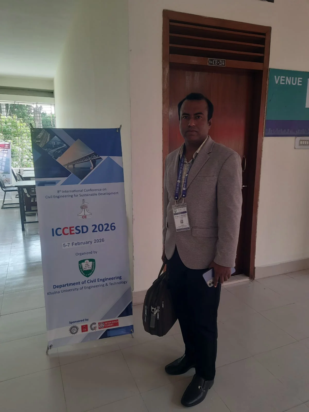 Engr. Munir Hossain Patoary beside the ICCESD 2026 poster at the venue